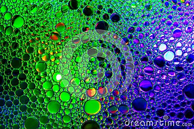 Colorful drops of oil on the water. Blue and green colored circles and ovals. Abstract background for design Stock Photo