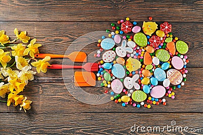 Colorful easter cookies and spatulas on table. Stock Photo
