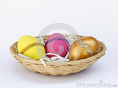 Colorful Easter egg in round basket Stock Photo