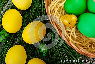 Easter eggs in the basket and with fake grass Stock Photo