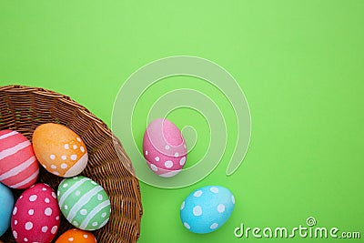 Colorful easter eggs in basket on green background Stock Photo