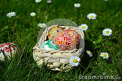 Colorful easter eggs on a basket on a green grass Stock Photo