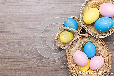 Easter eggs in the basket on wooden background Stock Photo