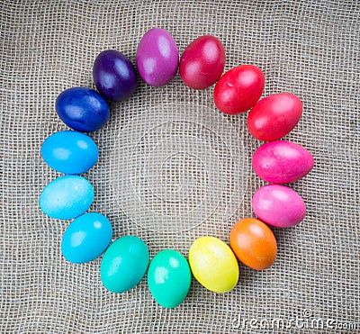 Colorful easter eggs round frame on sackcloth background Stock Photo