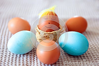 Colorful Easter eggs with smiling emoticon for hand-paintings at home. brown eggs face arranged together on the paper background, Stock Photo