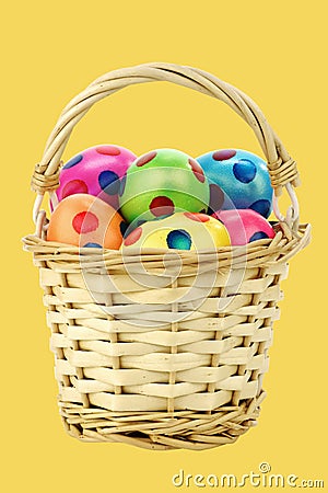 Colorful easter eggs in a wicker basket Stock Photo