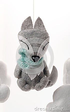 Colorful and eco-friendly children`s mobile from felt. A felt toy in the form of a lovely fox, part of a children`s mobile. On a Stock Photo