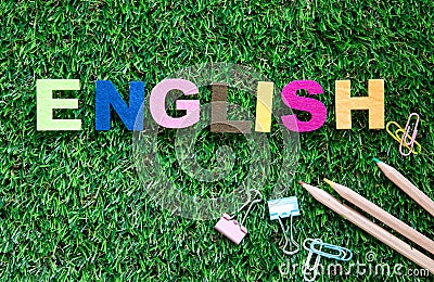 Colorful ENGLISH word cube on green grass yard background ,English language learning concept Stock Photo