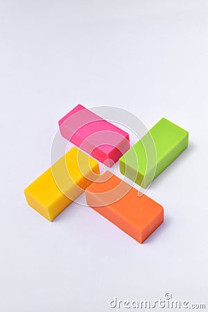 Colorful eraser. Pink, green, yellow and orange Stock Photo
