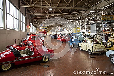 Colorful exotic cars and small airplanes hanging from the ceiling at Lane Motor Museum Editorial Stock Photo