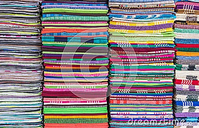 Colorful fabric and bath towels stacked in rows, pattern background. Stock Photo