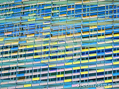 Colorful facade of a building with a vibrant rectangular window pattern. Glasses change color with sun time Editorial Stock Photo