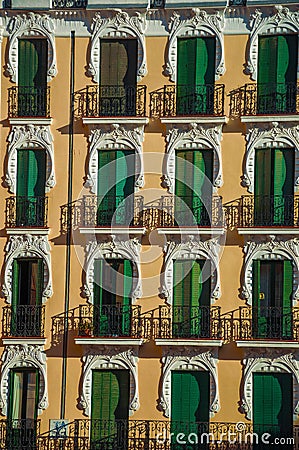 Colorful facade and windows with closed shutters in Madrid Stock Photo