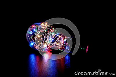 Colorful Fairy Light in a Light Bulb Shaped Glass Jar. Stock Photo