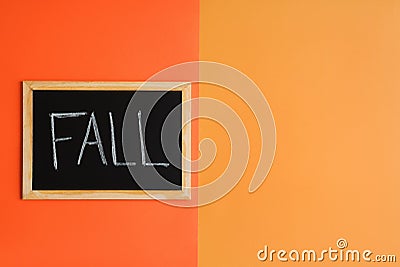 Colorful fall flat lay with blackboard with handwritten word `Fall` on a paper backdrop Stock Photo