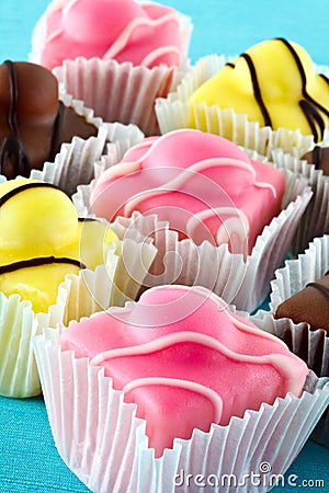 Colorful fancy iced fondant cakes. Stock Photo