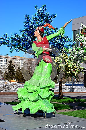 Colorful figure featuring dancing women in Astana Editorial Stock Photo