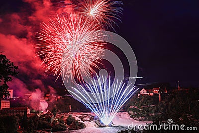 Colorful firework over the Rhine Falls to celebrate traditionally the Swiss National Day Stock Photo