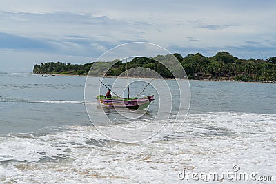 Colorful fishing boat beaching on a sri lankan beach, Arugam bay, Sri lanka Editorial Stock Photo