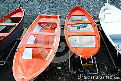 Colorful fishing wooden boat moored on the beach - coral color Editorial Stock Photo