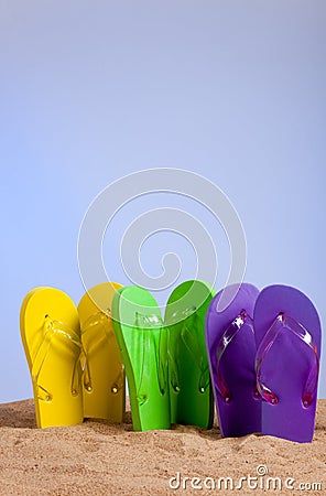 Colorful Flip-Flop Sandles on a Sandy Beach Stock Photo