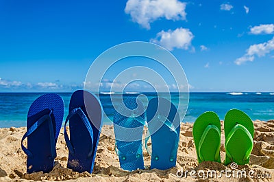 Colorful flip flops on the sandy beach Stock Photo