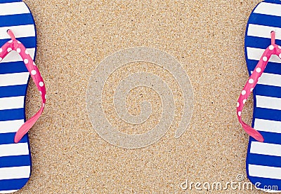 Colorful flipflop pair on beach sand Stock Photo