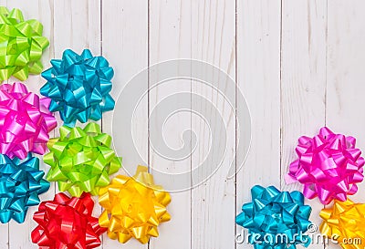 Colorful flora satin bows on wooden background with copy space Stock Photo