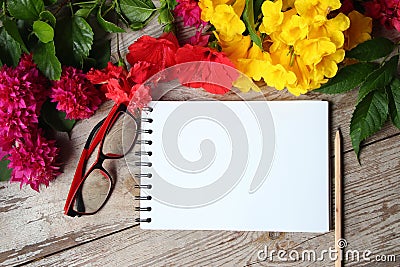 Colorful florals wite notebook placed on the table old wooden Stock Photo