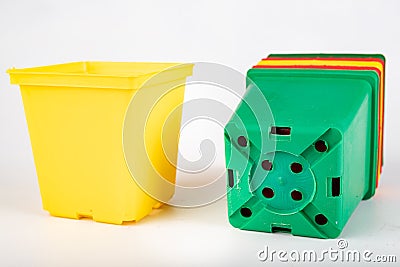 Colorful flowerpots on a white table. Accessories for gardeners Stock Photo