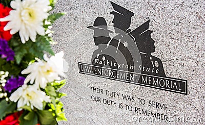 Colorful flowers frame a law enforcement memorial Editorial Stock Photo