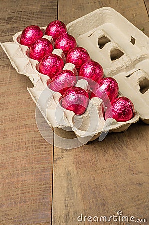 Colorful foiled eggs in container Stock Photo