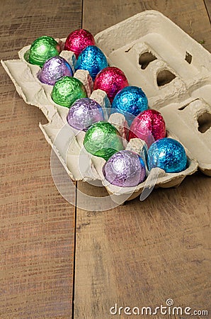 Colorful foiled eggs in container Stock Photo