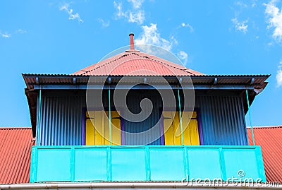 Colorful house with balcony against blue sky. Centre De La Ville De Victoria Seychelles Editorial Stock Photo