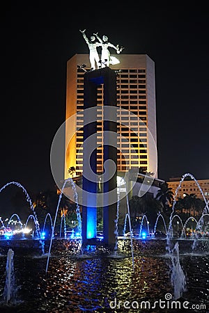 Colorful fountain show at iconic statue of Patung Selamat Datang at Bundaran HI in Jakarta central business district Editorial Stock Photo