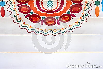 A colorful fragment of the Russian pattern in the style of Dymkovo on wooden wall painted in white Editorial Stock Photo