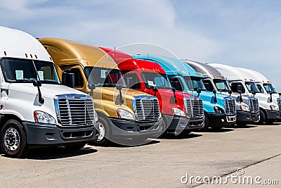 Indianapolis - Circa June 2018: Colorful Freightliner Semi Tractor Trailer Trucks Lined up. Freightliner is owned by Daimler AG II Editorial Stock Photo