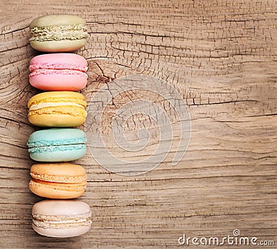 Colorful French Macarons on wood background Stock Photo