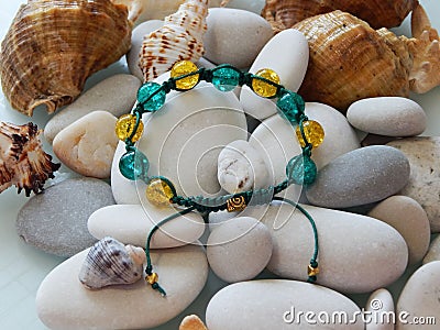 Colorful friendship bracelet and pebble Stock Photo