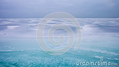Colorful frozen lake surface during a heavy overcast day Stock Photo