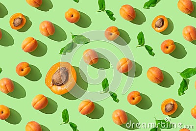 Colorful fruit pattern seamless with fresh apricots on green pastel background, top view, flat lay. Trendy wrapping paper, cover, Stock Photo