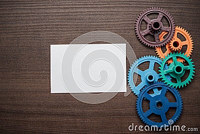 Colorful gears on the brown wooden background Stock Photo