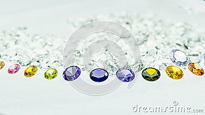 .colorful gems displayed in the middle of a white diamonds. Stock Photo