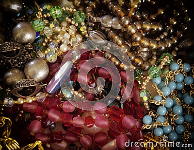 Colorful gems and golden fashion jewels closeup, top view Stock Photo