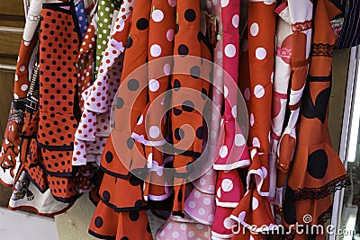 Colorful gipsy flamenco dresses on rack hanged in Spain market Stock Photo