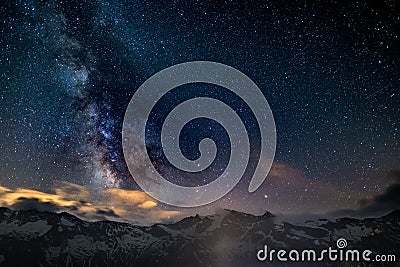 The colorful glowing core of the Milky Way and the starry sky captured at high altitude in summertime on the Italian Alps, Torino Stock Photo