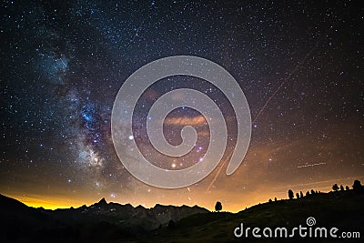 The colorful glowing core of the Milky Way and the starry sky captured at high altitude in summertime on the Italian Alps, Torino Stock Photo