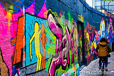 Colorful graffity in Werregarenstraat Graffiti Street in Ghent, Belgium, Europe, with defocused background with a person on a Editorial Stock Photo