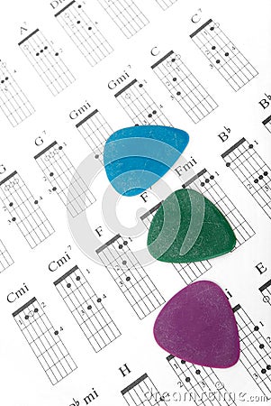 Colorful guitar picks on a chords chart Stock Photo