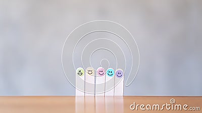 Colorful hand draw happy emotion faces on wooden stick Stock Photo